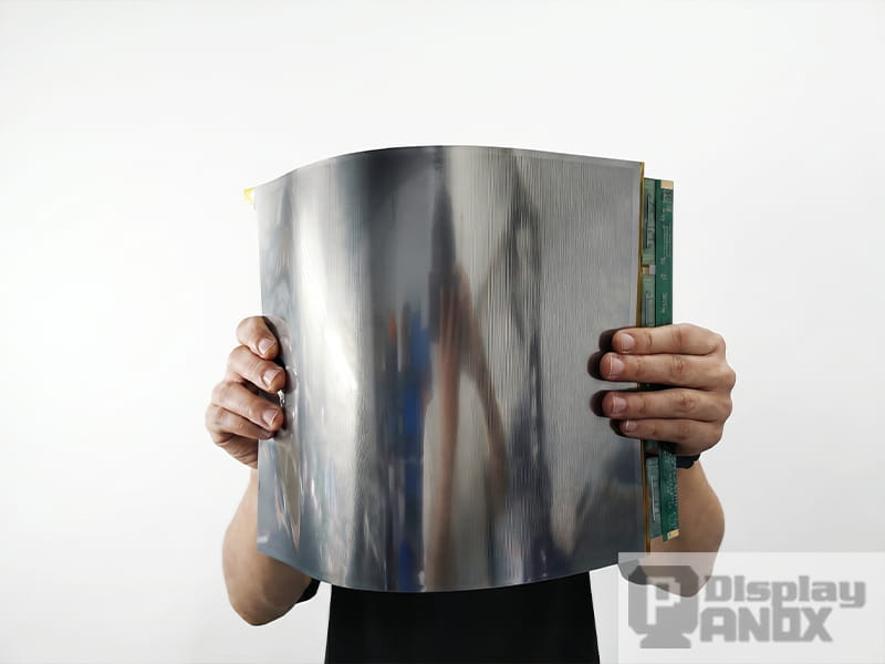 16.3 inch flexible OLED large curved display panel held by hand, showing bendable screen structure and side driver board