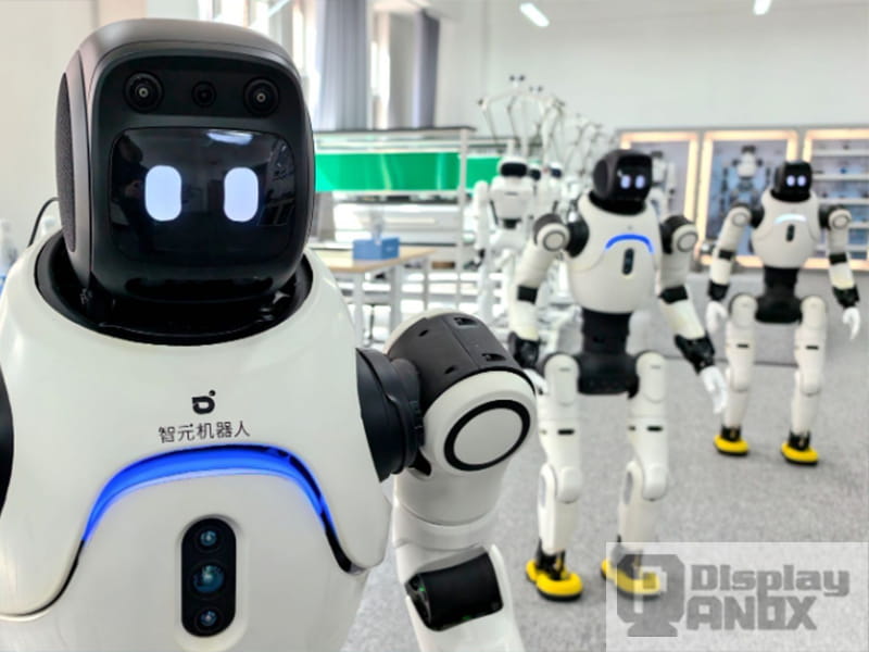AgiBot (Zhiyuan Robotics) humanoid robots with flexible OLED face displays in a Shanghai showroom, showing the new generation of robot eye displays