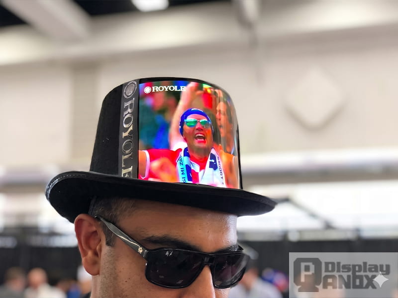 Royole flexible OLED curved display integrated into top hat showcasing wearable flexible display application